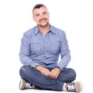 Tutor sitting cross legged on floor