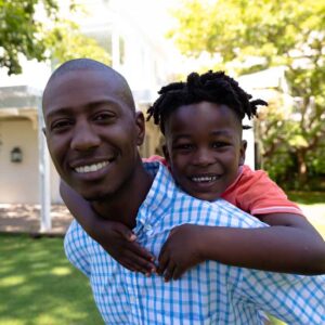 man with child on shoulder